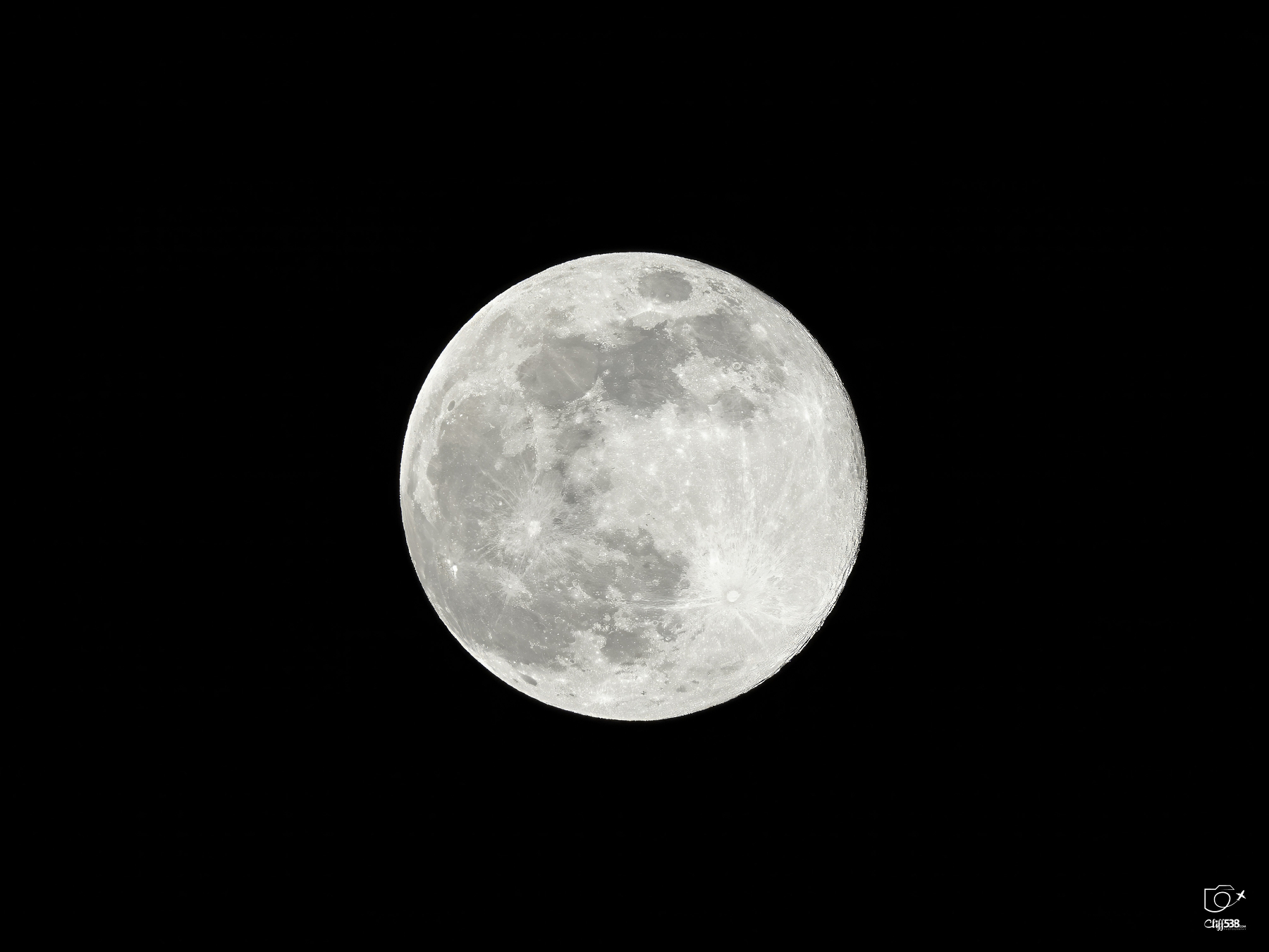 Auto-generated description: A full moon is prominently displayed against a dark night sky.