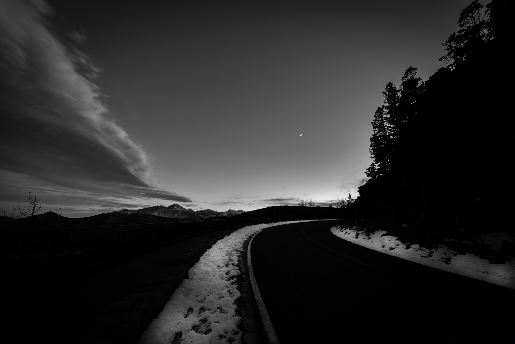 Dark winter road winding through the mountains.