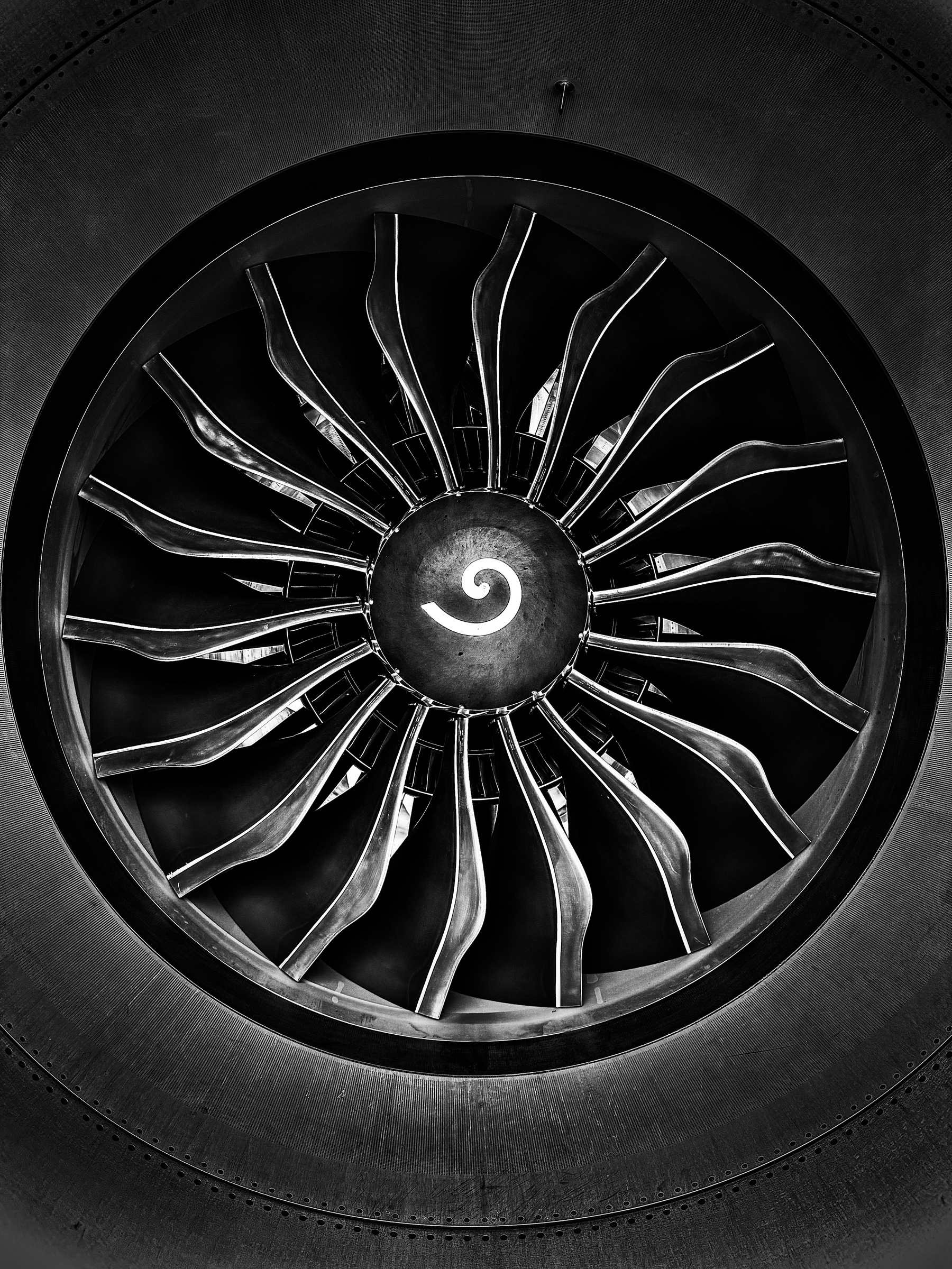 black and white photo of the fan blades of an aircraft engine.