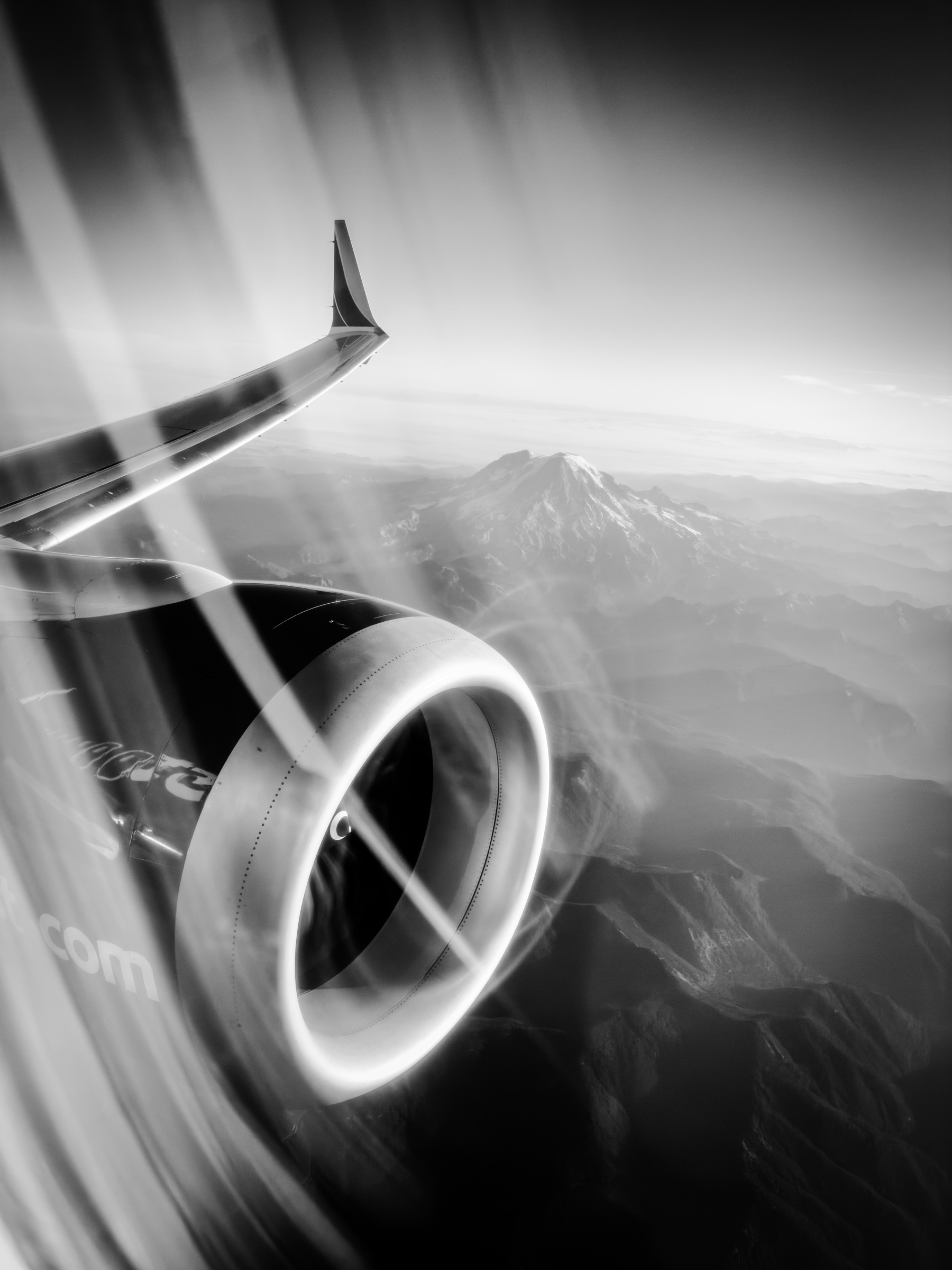 black and white photo out an airplane window of Mt Ranier.