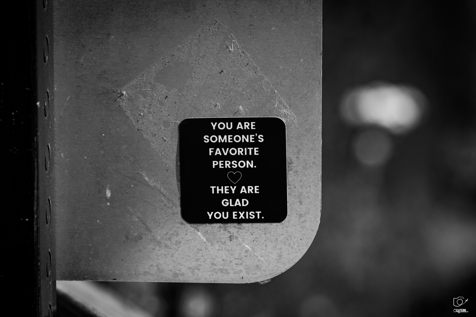 Auto-generated description: A small black sign with white text and a heart symbol displays a positive and affirming message about being someone's favorite person and being appreciated.