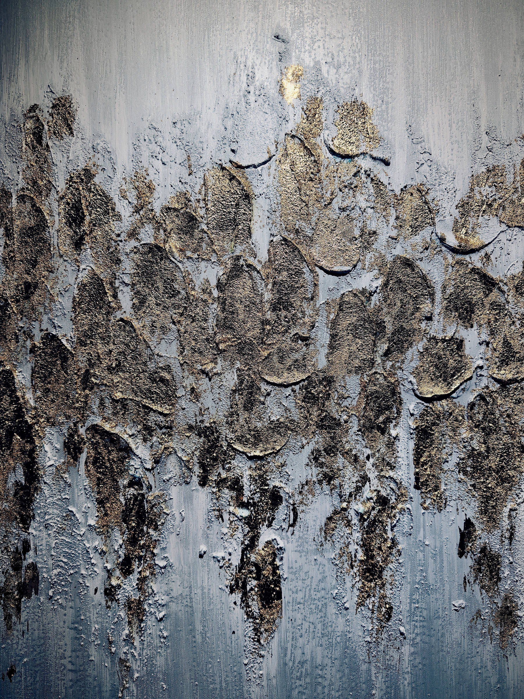 Auto-generated description: An abstract textured painting features rough, layered patches of dark brown and gold hues against a muted gray-blue background.